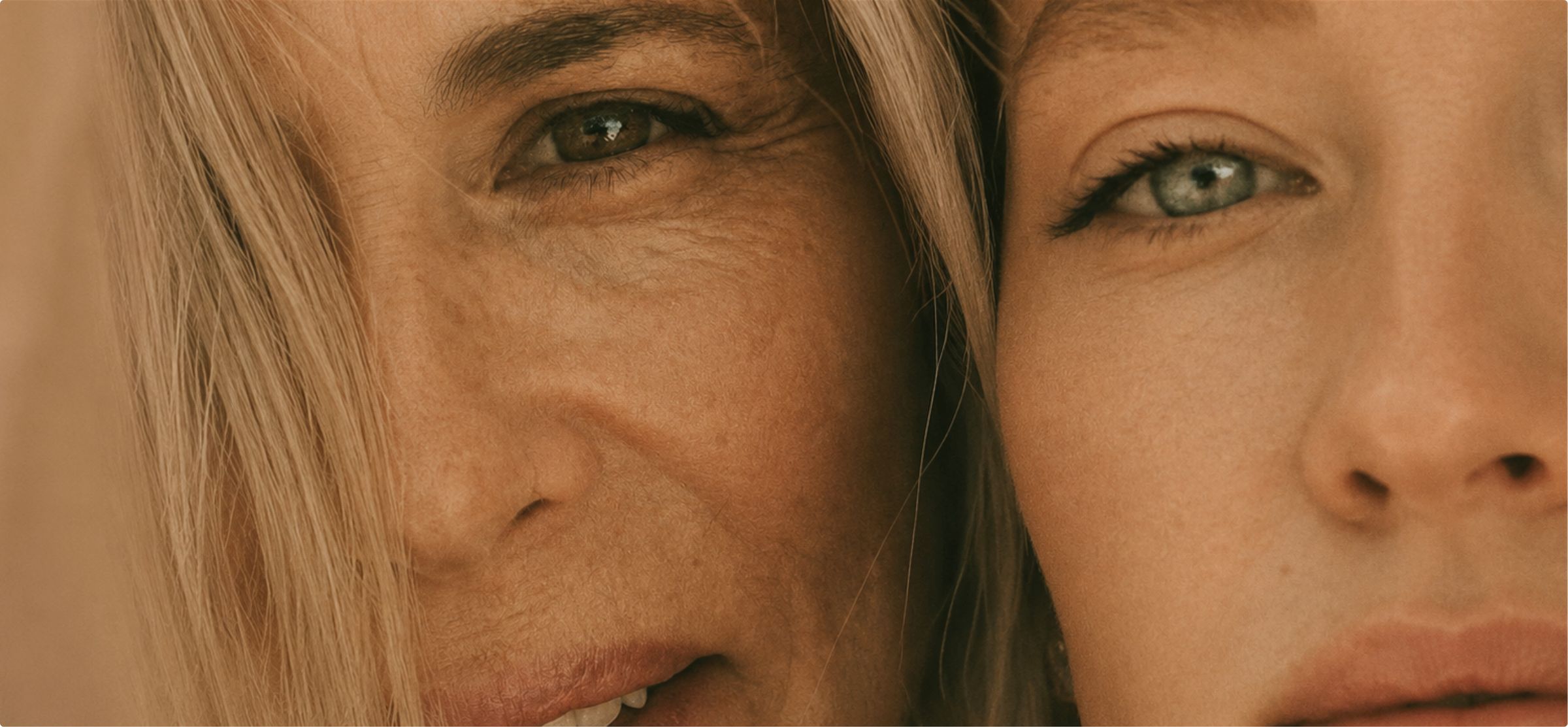 Close-up of an older and a younger woman cheek to cheek